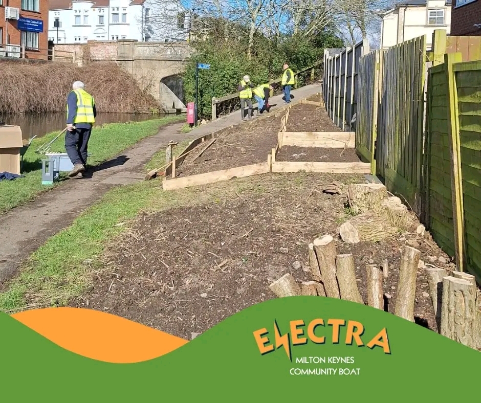 image from the electra boat mk facebook page of volunteers building flowerbeds along the grand union canal in milton keynes